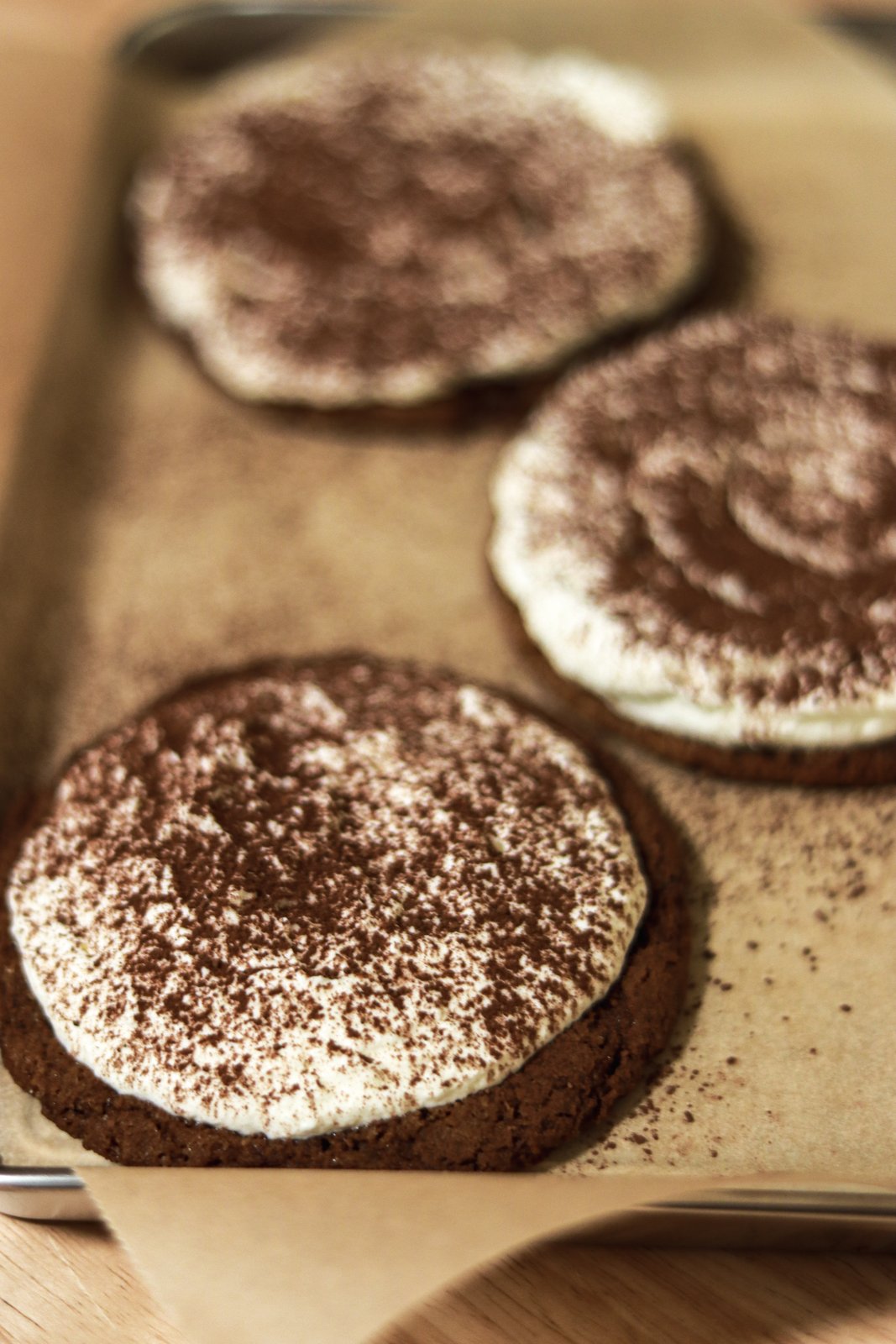 Cocoa-dusted individual desserts on parchment